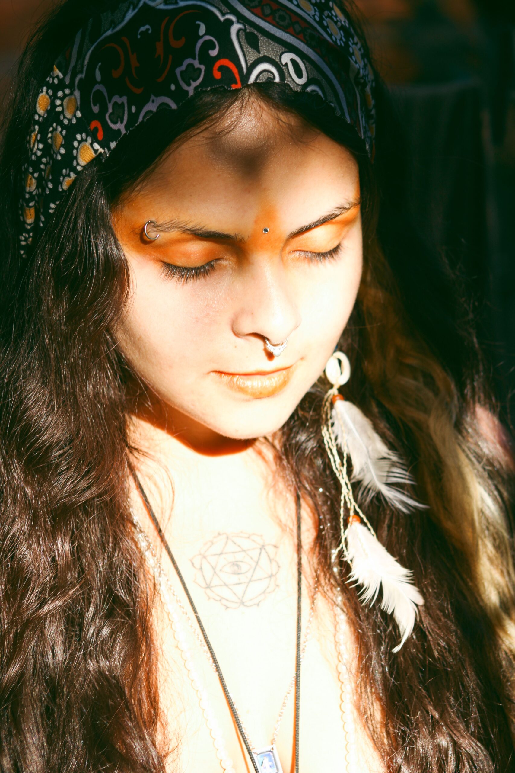 woman meditating with markings across her third eye chakra
